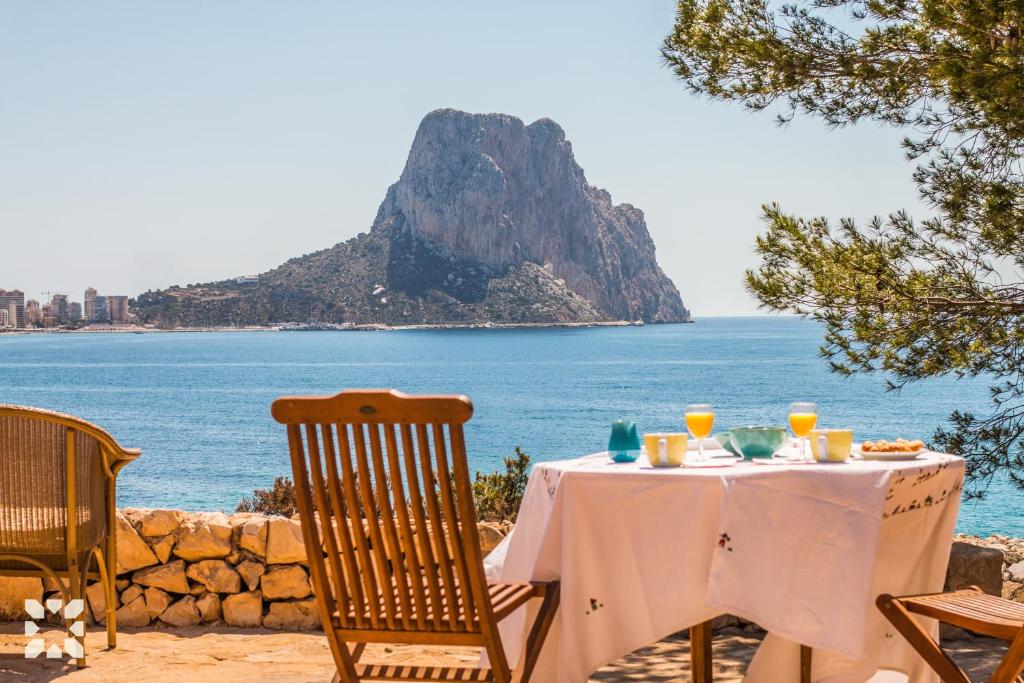 a table with a view of the ocean at Villa Timeris by Abahana Villas in Calpe