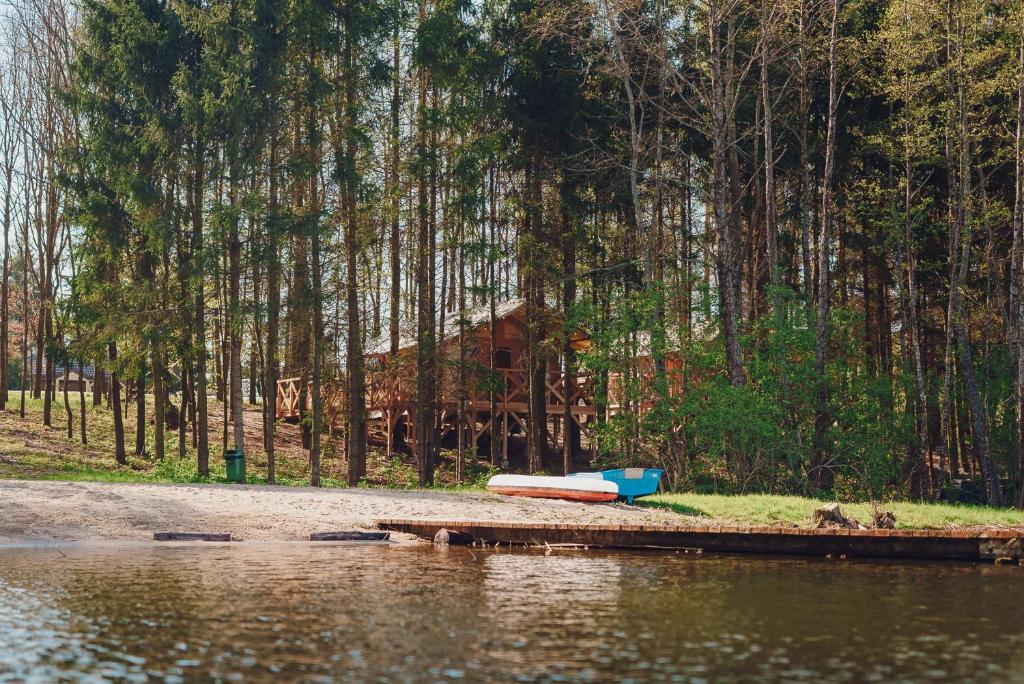 a house on the shore of a body of water at Glamping Mazury - Przystań Jeziorany in Jeziorany