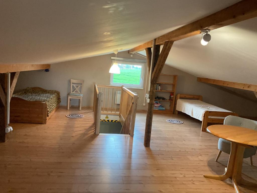 a attic room with two bunk beds and a staircase at Ferienhaus Bartelshagen 1 in Marlow