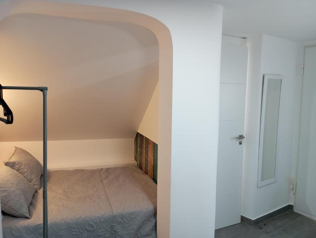 a small bedroom with a bed and a door at Gaviotas Beach Golf Love 11 in Almerimar