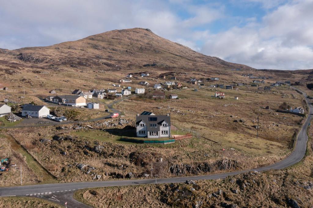 a house on the side of a hill with a road at Castlebay View in Castlebay