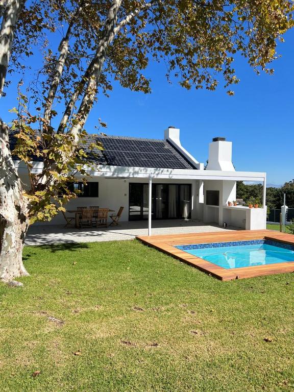 a house with a swimming pool in the yard at Chasselas Self Catering in Cape Town