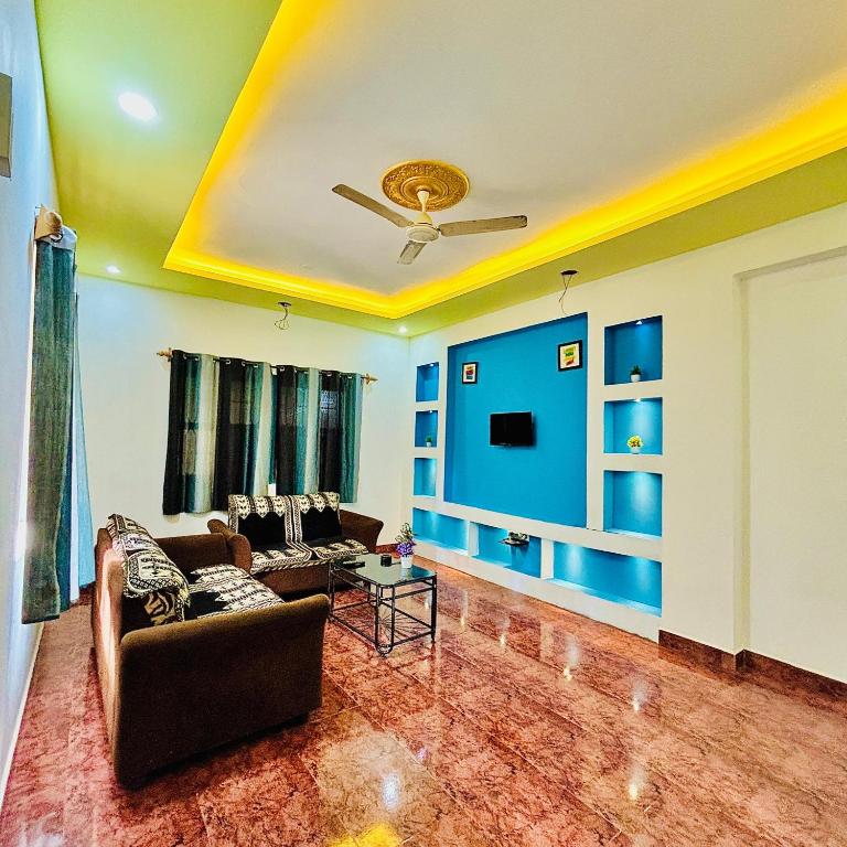 a living room with a couch and a ceiling at The Grey Villa - Private Pool in Calangute