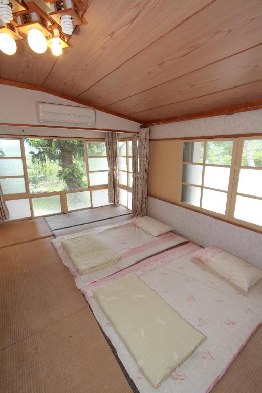 an empty room with windows and mats on the floor at JS Hotspring in Ruisui
