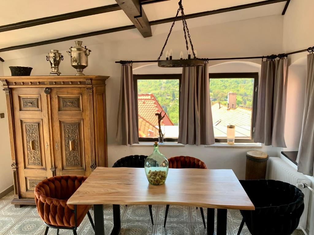 a dining room with a wooden table and chairs at Boutique Apartments U Rolanda in Znojmo