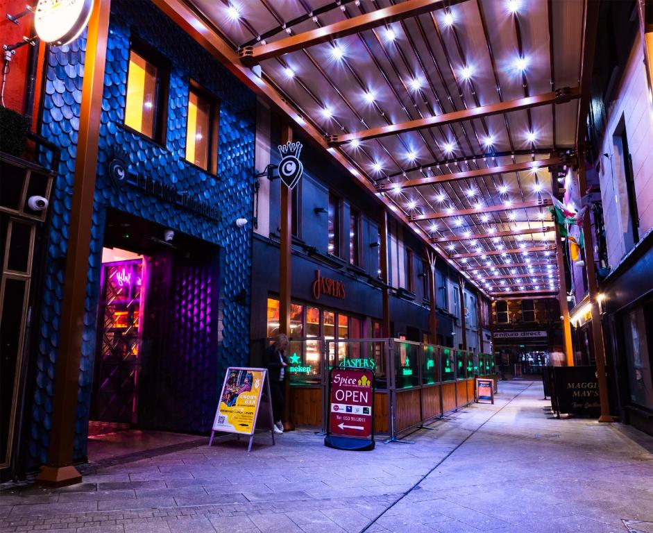 una calle vacía con un edificio con luces. en Crown Quarter, en Wexford