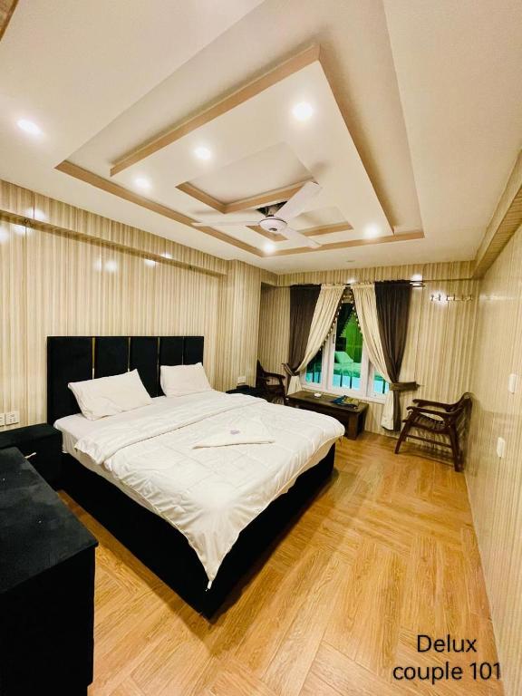 - une chambre avec un grand lit blanc et un canapé dans l'établissement Hotel five star Skardu, à Skardu
