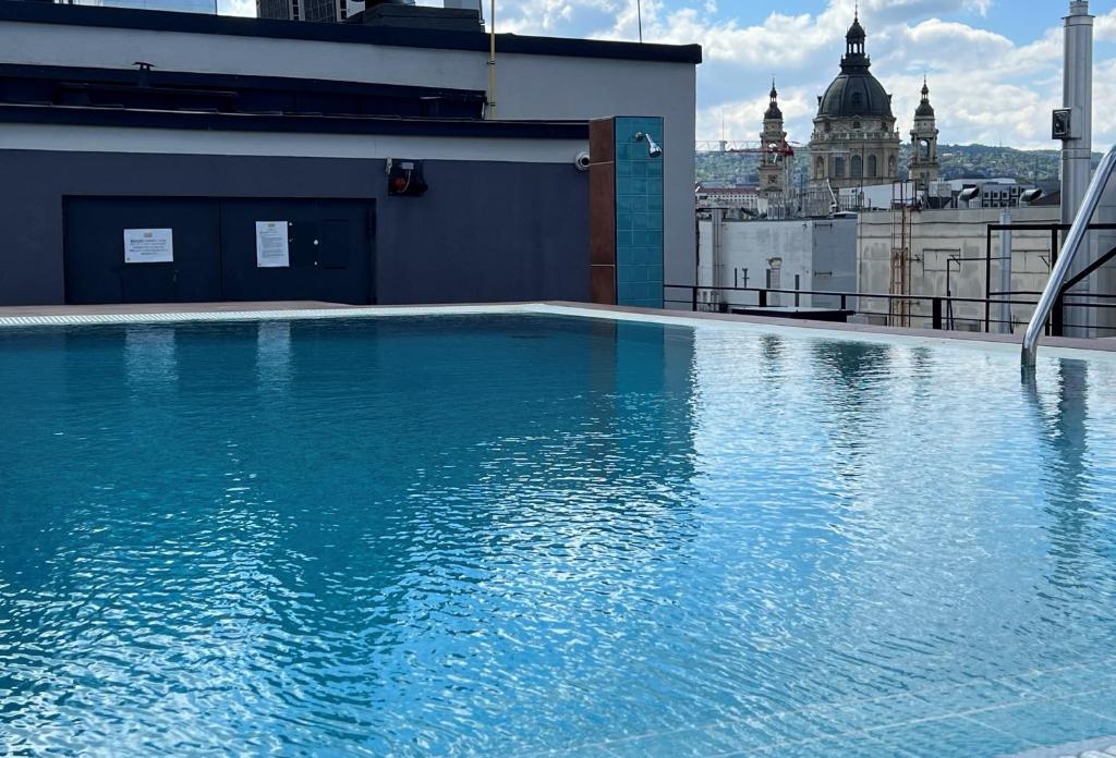 a large swimming pool on top of a building at Luxury Studio in Downtown, Free Parking & Pool in Budapest