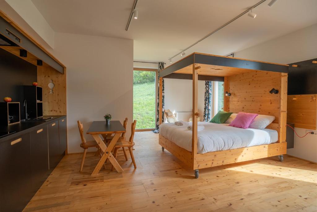a bedroom with a canopy bed and a table at Eco Glamping Resort Krištof in Cerklje na Gorenjskem