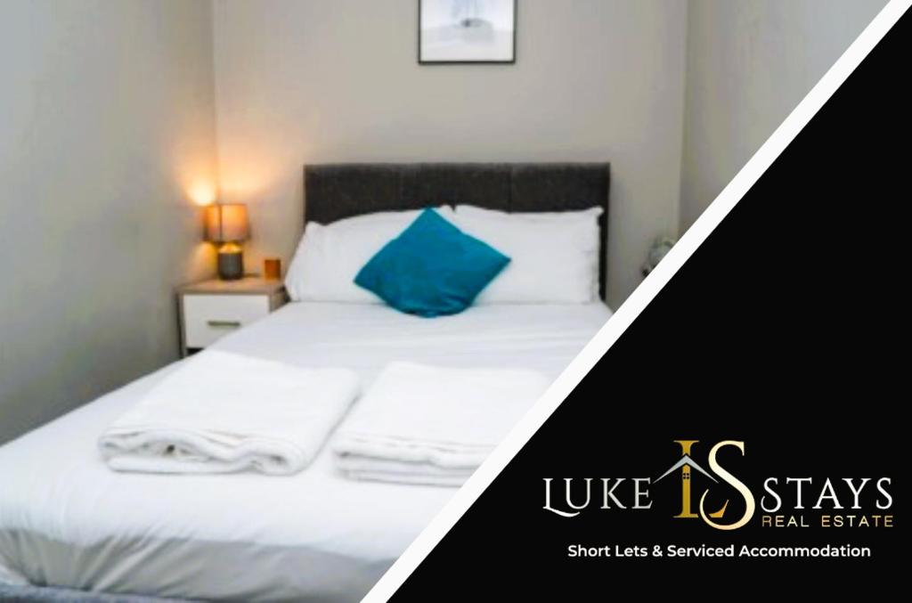 a bedroom with a bed with a blue pillow at Luke Stays - Front Street in Newcastle upon Tyne