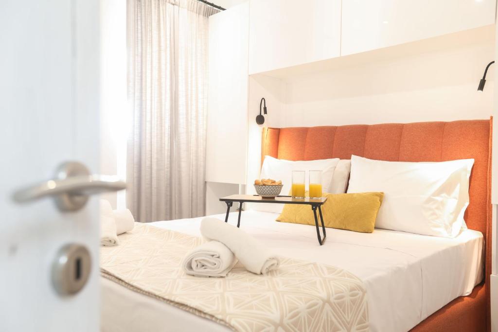 a bedroom with a large bed with a table on it at Arieni Places in Corfu