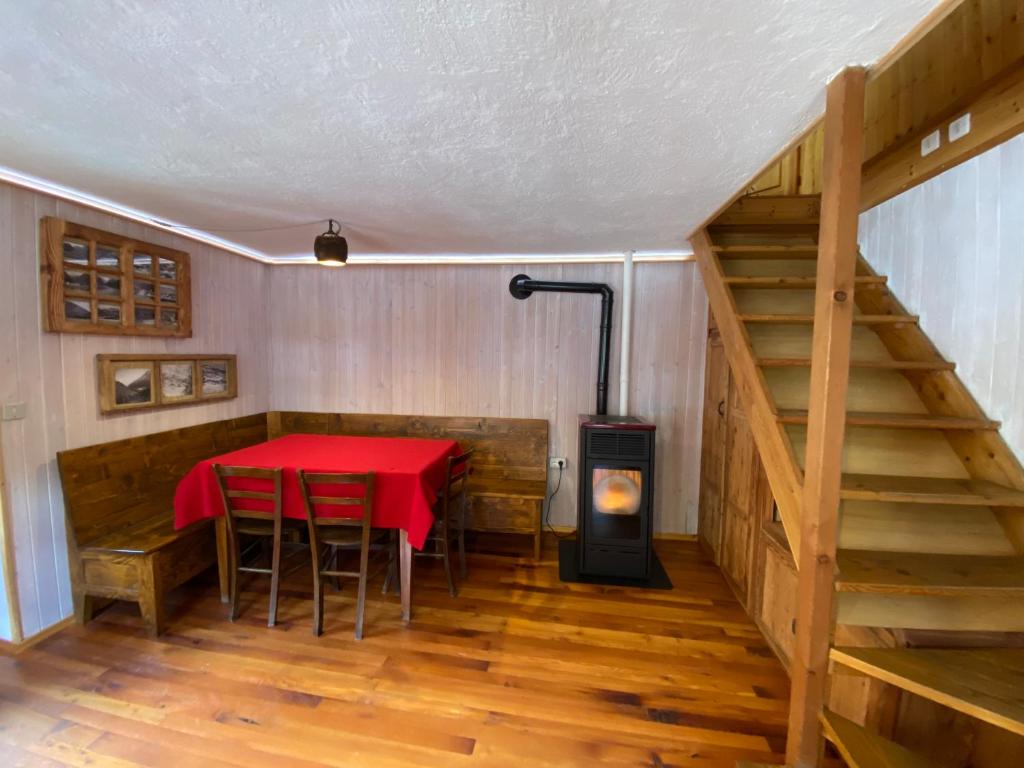 una camera con tavolo e stufa a legna di Lou Mitti Gontier a Champorcher