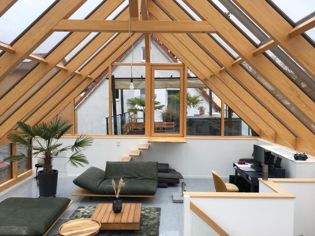 an attic living room with a vaulted ceiling at Traumhaftes Loft Wintergarten in Schwabach