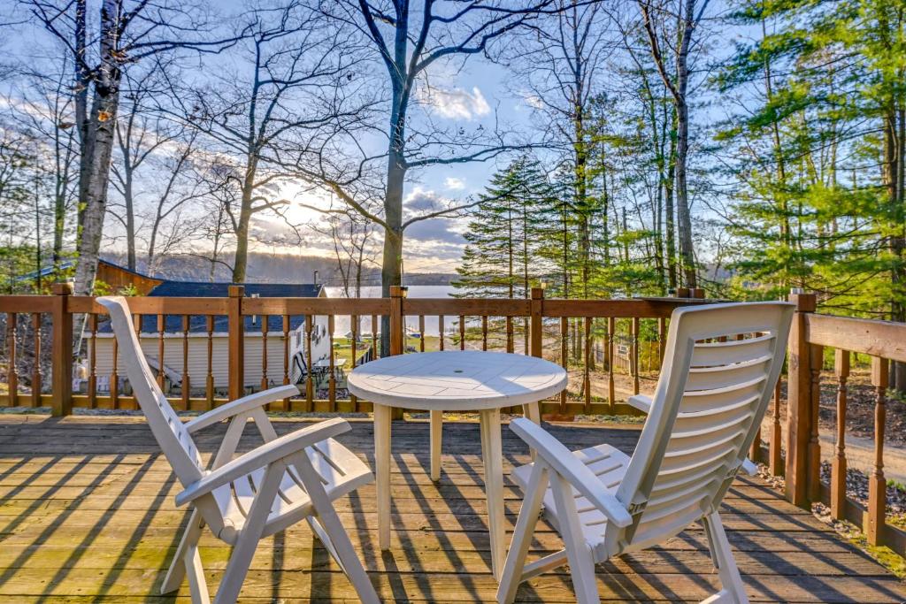 two chairs and a table on a deck at Cottage with Deck and Bluff Lake Views Walk to Beach! in Lake