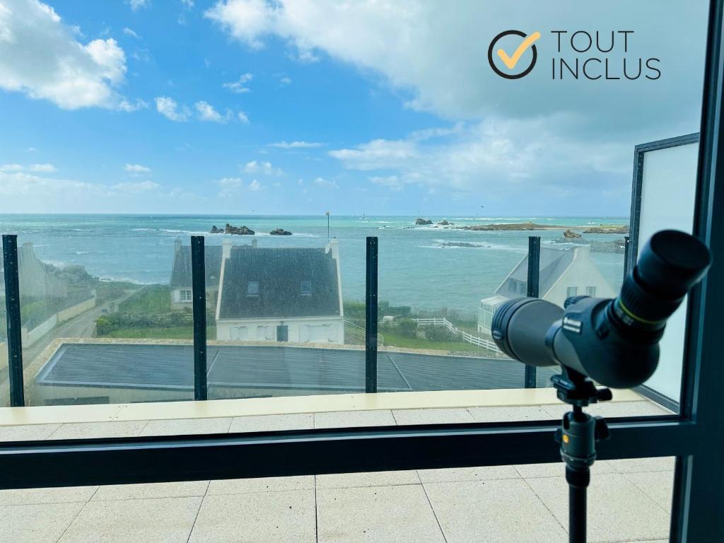 a view of the ocean from a window with a camera at AR SKOL - Magnifique duplex face à la mer in Porspoder