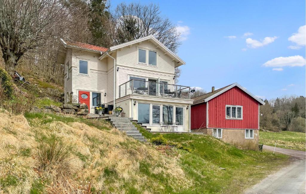 una casa en una colina con una casa roja en Awesome Home In Kungsbacka With House Sea View, en Kungsbacka