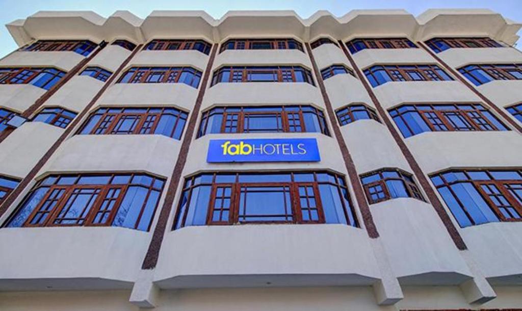 a building with the ibid hotels sign on it at FabHotel Prime Grand Ali in Srinagar