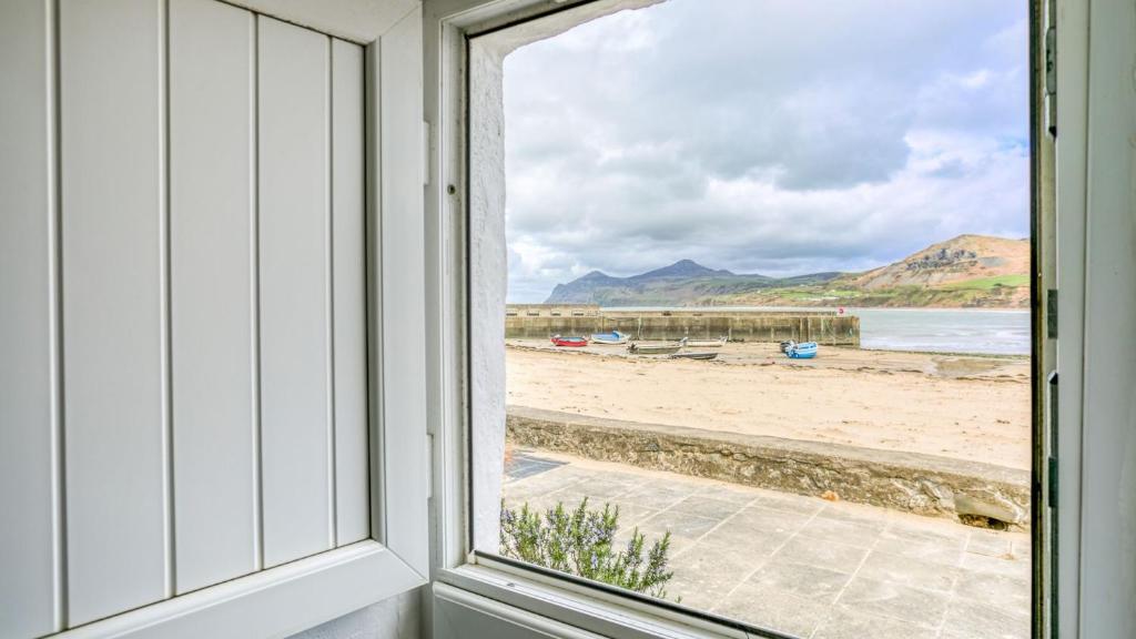 a window view of the beach from a house at Hen Dafarn in Nefyn
