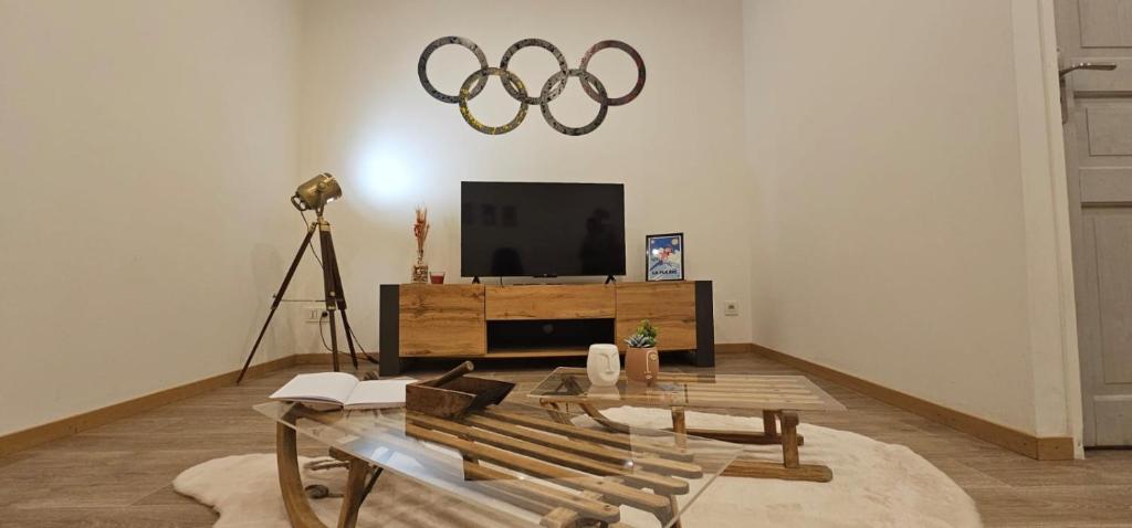 a living room with a table and a television and a camera at Le Refuge T3 centre ville 63m2 pied des montagnes in Albertville