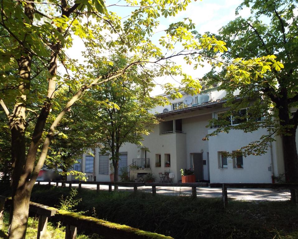 a white house with trees in front of it at Ferienwohnung Lahnbachallee, Schwaz in Schwaz
