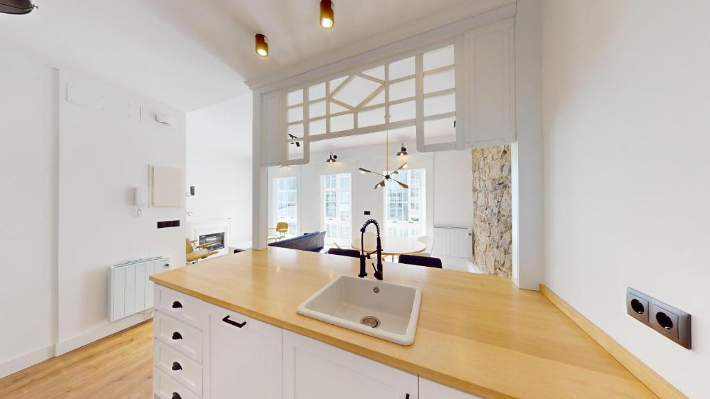 a kitchen with a sink and a large window at Piso nuevo-Plaza Armas in Ferrol