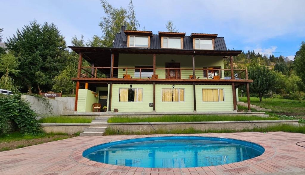 a house with a pool in front of it at Buena Vida Social Club in El Bolsón