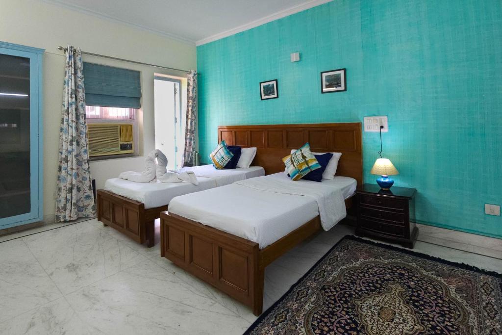 Postel nebo postele na pokoji v ubytování Prakash Kutir B&B