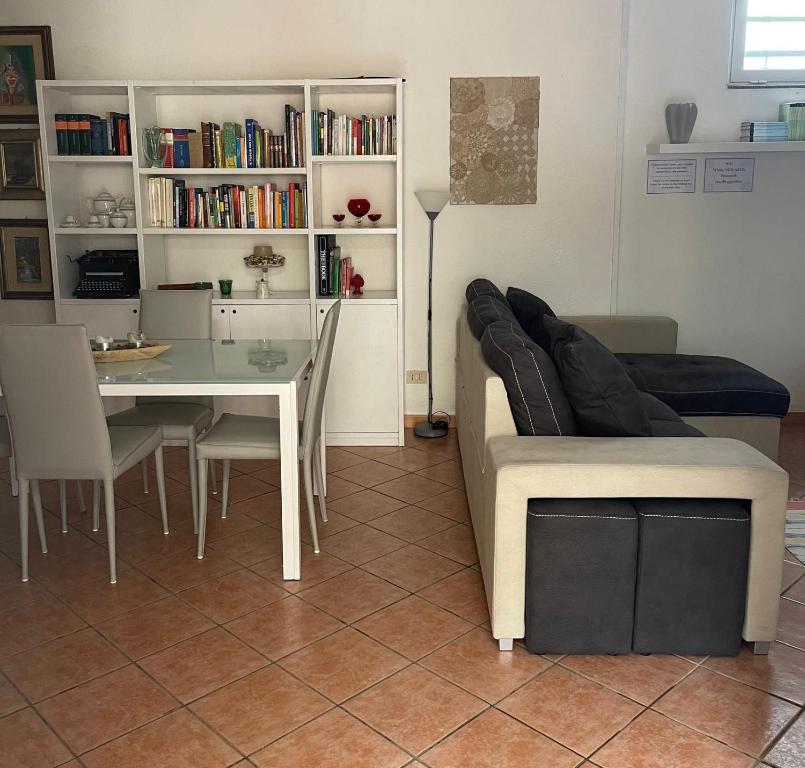 a living room with a table and a couch at FINESTRA SUL MARE in Palermo