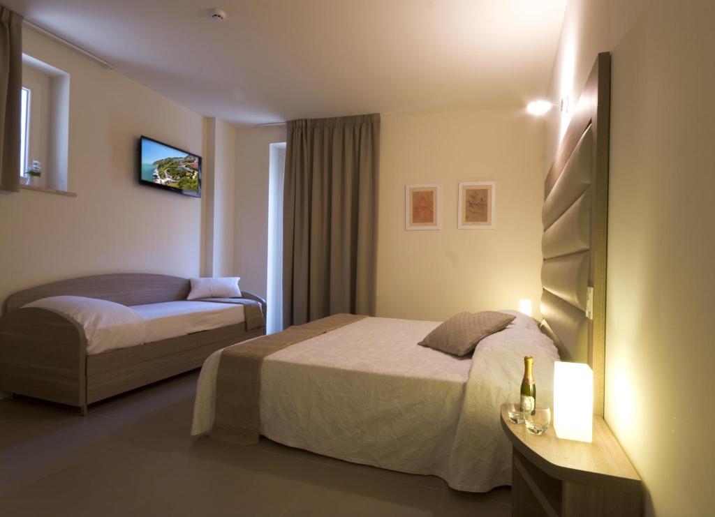 Postel nebo postele na pokoji v ubytování Palazzo Ruschioni Boutique Hotel