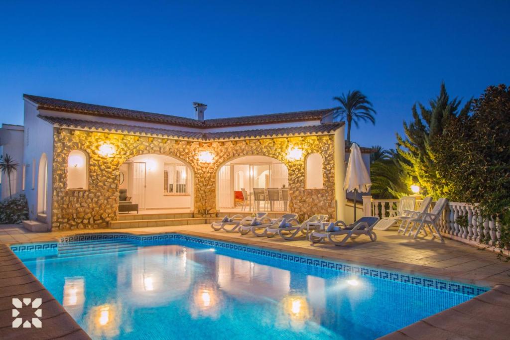 a villa with a swimming pool at night at Villa Soleada by Abahana Villas in Calpe
