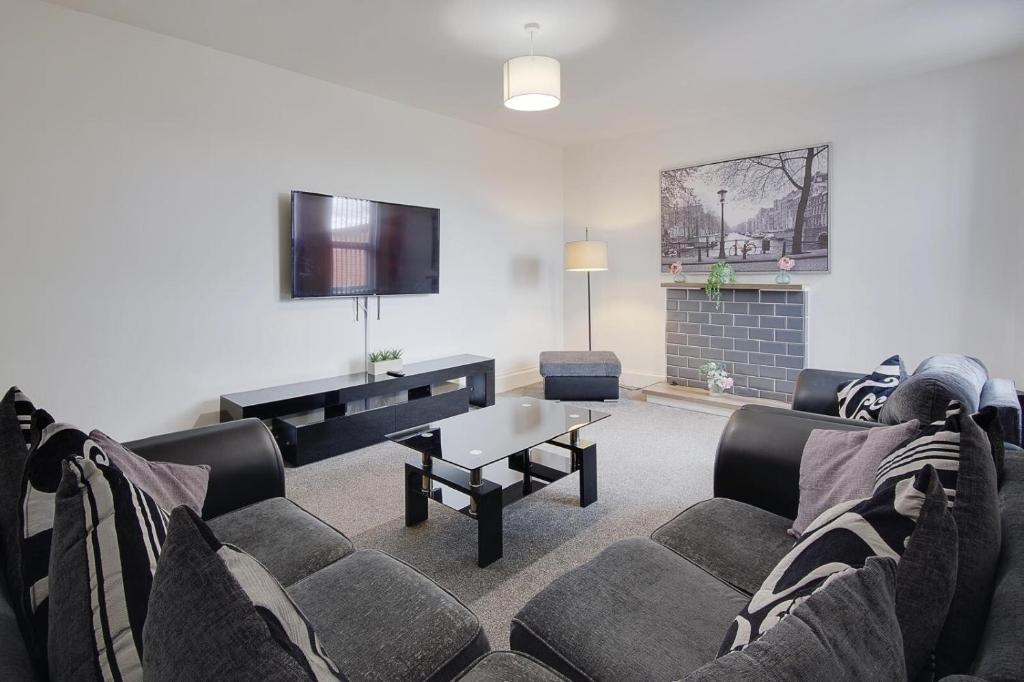a living room with a couch and a table at Wimbourne Road Apartment 3 in Bournemouth
