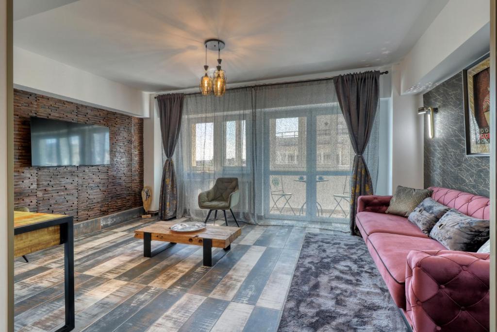 a living room with a couch and a table at RDI Elegance Apartment Downtown in Bucharest