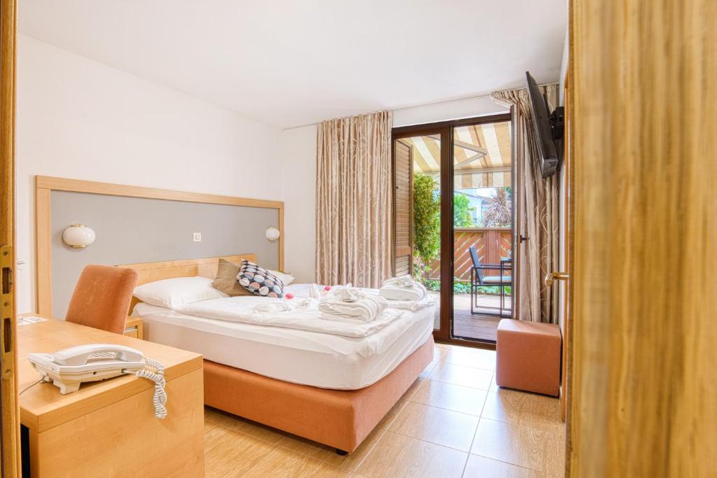 a bedroom with a bed with a phone in it at Boutique Hotel Santa Maria in Novigrad Istria