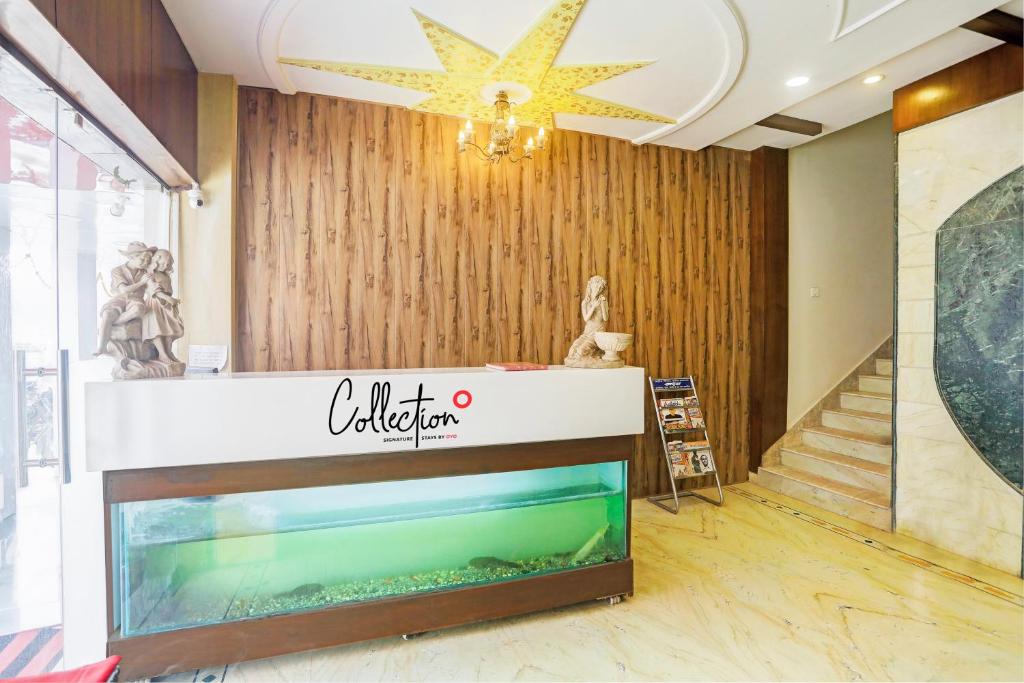 a lobby of a store with a fish tank at Collection O Hotel Sunbeam in Gwalior