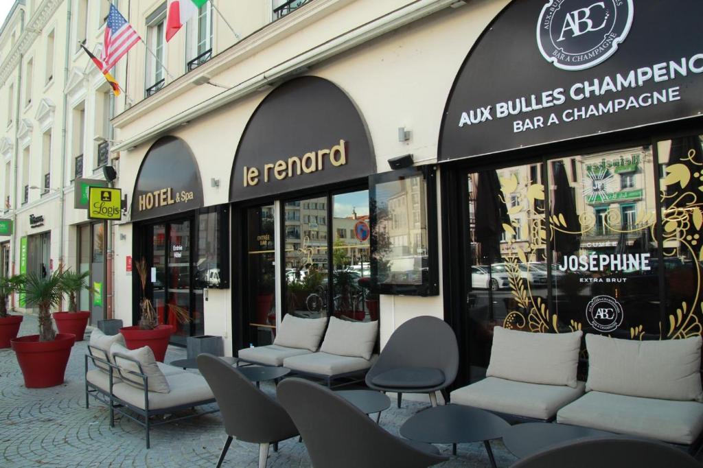 una fila di sedie seduta di fronte a un edificio di HOTEL & SPA Le Renard Centre a Chalons en Champagne