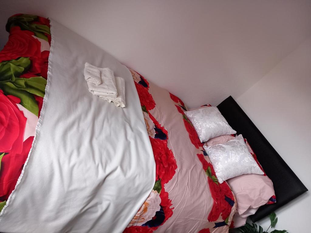 a bed with two pillows on top of it at Beautiful 5-Bed House in Dagenham newly Renovated in Dagenham