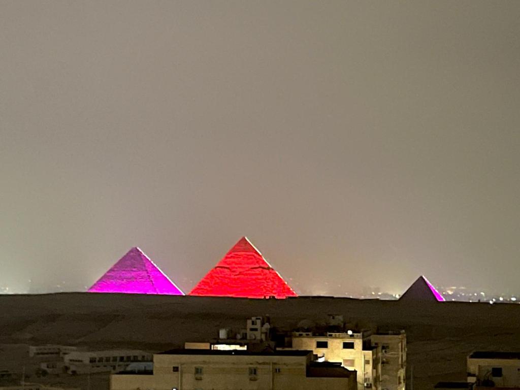 a view of the pyramids of giza at night at Panorama 3 Pyramids View Inn in Giza