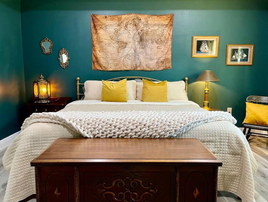 a bedroom with a large bed with yellow pillows at Sanford's Seahaven in Sanford