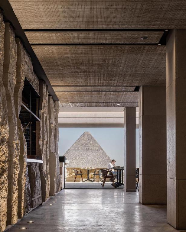 a view of the pyramids from the hallway of a building at Pyra Hospitality West Pyramids Cairo in Cairo