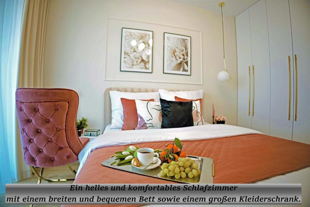 a bedroom with a bed with a tray of fruit on it at Gea Eco Appartment 200m von Ostsee WiFi mit incl Parkplatz in Sianozety