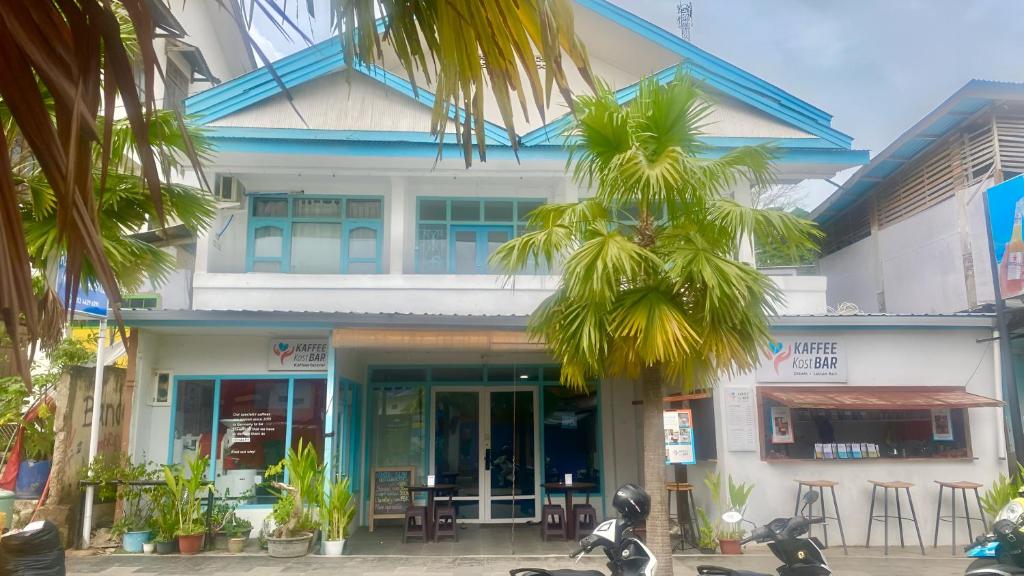 a building with motorcycles parked in front of it at Komodo Indah Hotel in Labuan Bajo