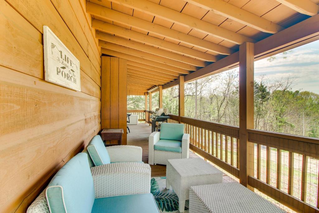 une terrasse couverte avec des chaises et des tables. dans l'établissement Cozy Cabin with Grill and Fire Pit By Dale Hollow Lake, à Frogue