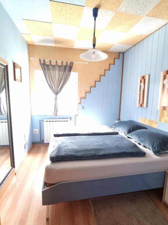 a bedroom with a bed and a staircase at Holiday Home Baotic in Velika Mlaka
