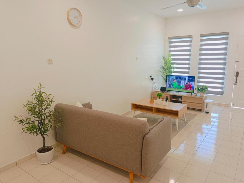 a living room with a couch and a tv at Riverfront City, Up to 8 Pax, 3 Bedrooms, 2 Bathrooms, 2 Car Park by Star Home in Sungai Petani