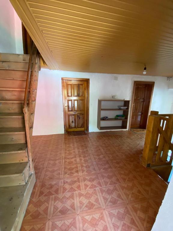 a living room with a staircase and a room with a floor at Guesthouse Sibora in Valbonë