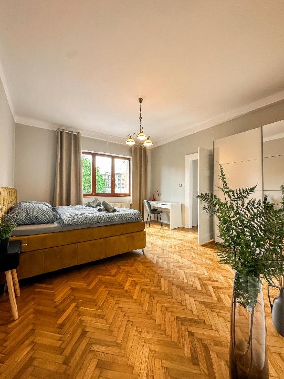 a bedroom with a large bed and a wooden floor at 3 - room Masaryk A 100m2 City Centrum Kosice in Košice