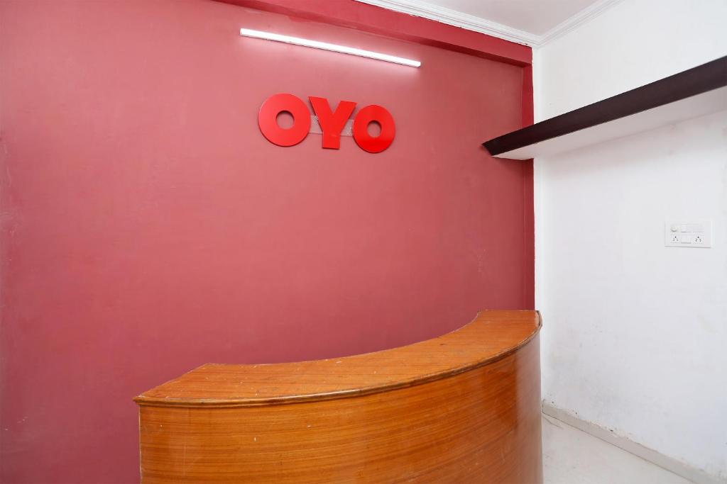 a red wall with ayo sign on a wall at Collection O The Vinayak in Bhopal