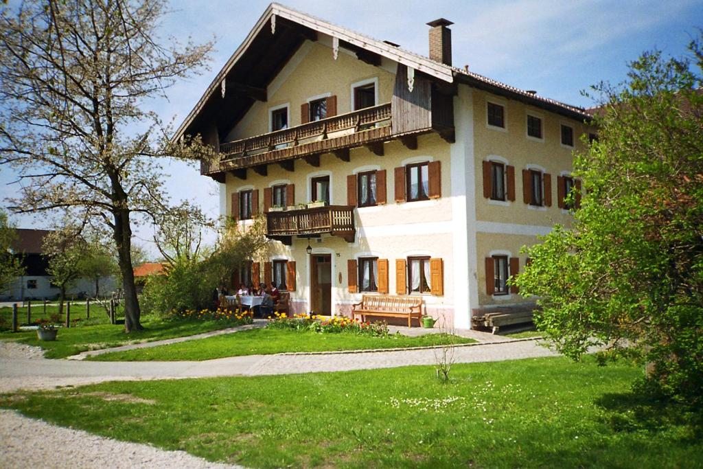 a large house with a balcony on the side of it at Bauernhof Geigerhof in Aschau im Chiemgau