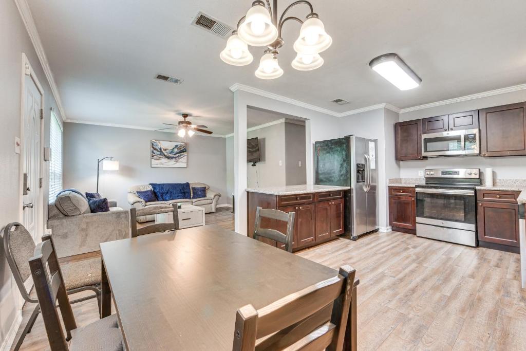a kitchen and living room with a table and a couch at Baton Rouge Home with Yard about 14 Mi to Downtown! in Baton Rouge