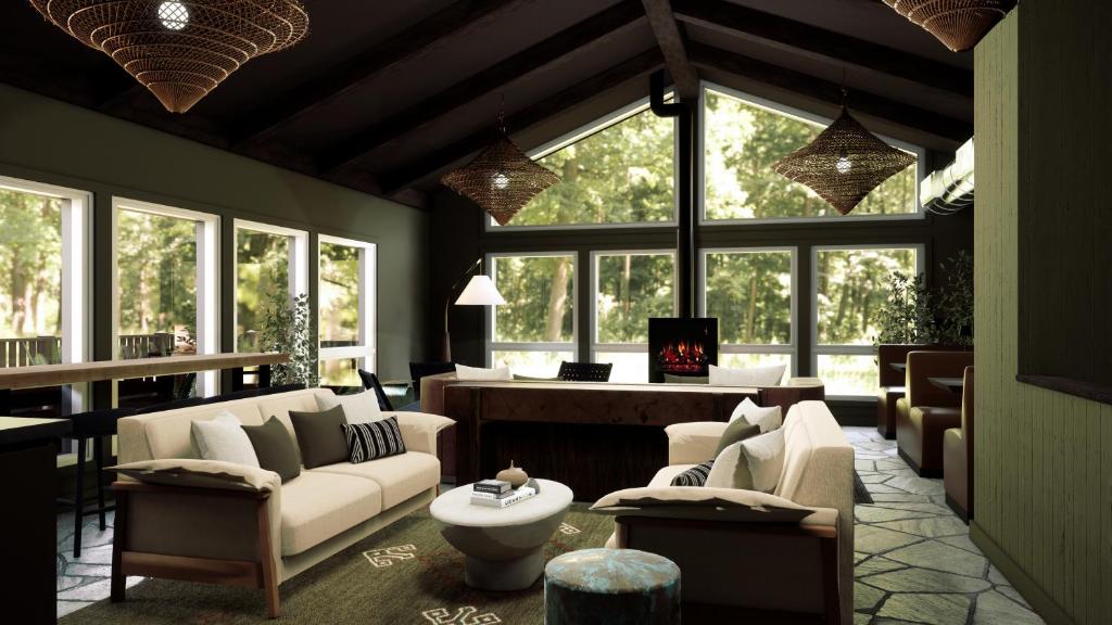 a living room with white furniture and large windows at AWOL Stowe in Stowe